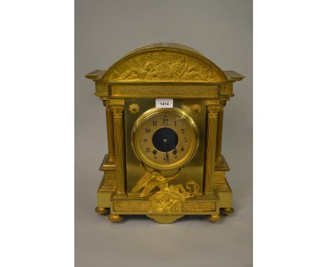 19th Century French gilt brass mantel clock of architectural form, the broken arch top inset with a classical frieze, the cir