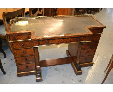 Unusual Gillow amboyna breakfront writing table, the leather inset top with brass gallery above pedestal drawers on a plinth 