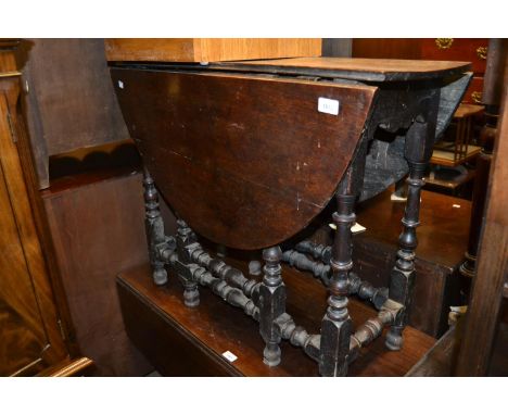 Small early 18th Century oak oval gate leg table with a single end drawer on baluster turned supports with stretchers 