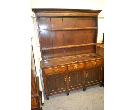 19th Century oak dresser, the boarded shelf back above three drawers and three panelled doors on stile feet, 59ins wide 