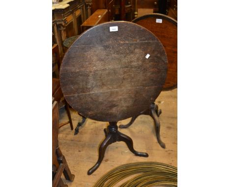 George III circular oak tilt-top pedestal table on turned centre column and tripod support 