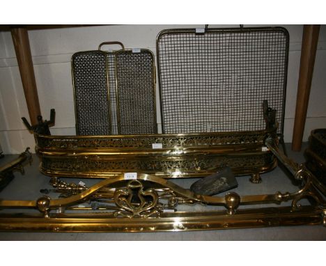 Two 19th Century brass fenders together with two brass firescreens and a quantity of fire tools 