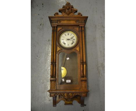 Late 19th or early 20th Century Continental walnut Vienna wall clock, the shaped surmount above an enamel dial with Roman num