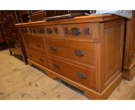 Large late Victorian oak chest, the moulded top above seven drawers with oval brass handles raised on bracket feet 