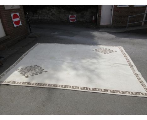 Large Tunisian woollen carpet of floral design with border on a beige ground, 13ft x 10ft 