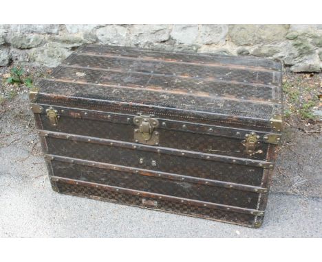 Louis Vuitton steamer trunk, circa 1900, with original canvas and wooden strapping and original brass fittings stamped LV, wi