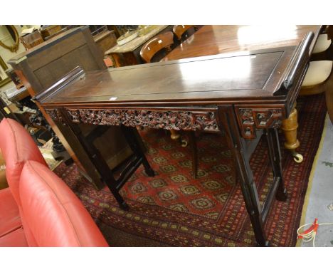 Chinese hardwood altar table, the rectangular top with scroll ends above a carved and pierced frieze on shaped and pierced su