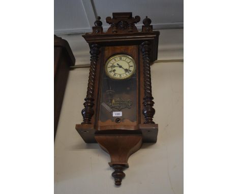 Small late 19th Century Continental walnut Vienna cased wall clock with two train movement, the case with flanking spiral pil