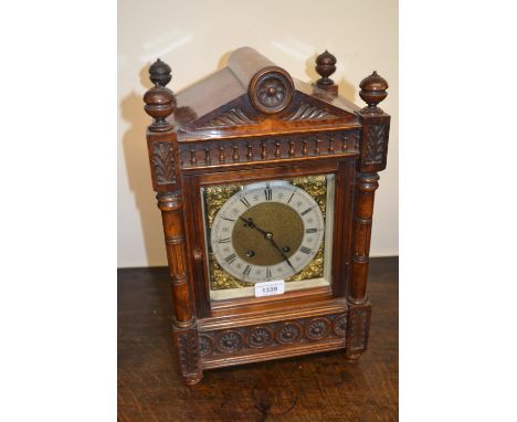 Late 19th or early 20th Century walnut bracket clock of Arts and Crafts design, the gilt brass dial with silvered chapter rin