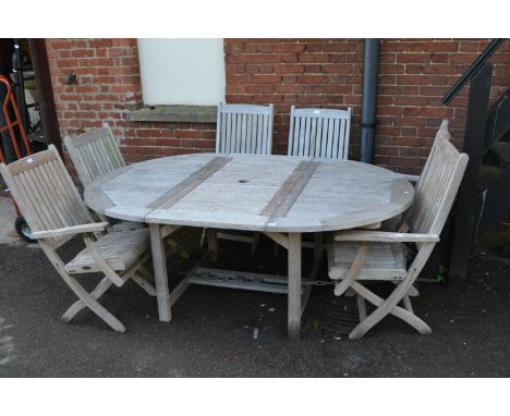 Good quality modern teak circular extending garden table by Westminster, together with six matching chairs 