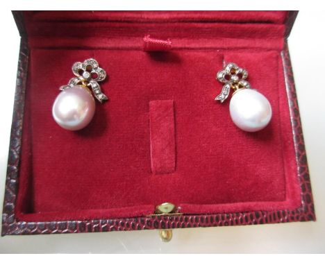 Pair of grey cultured pearl drop earrings set with diamond bow tops 