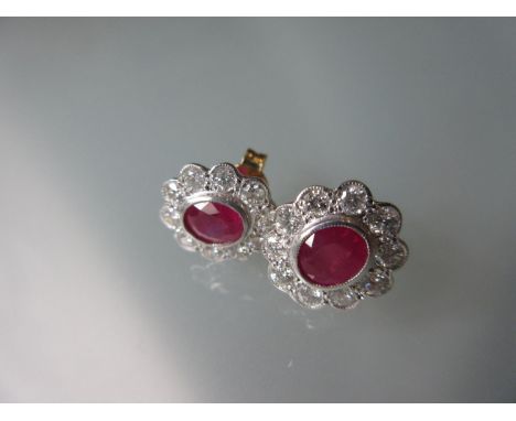 Pair of 18ct yellow gold oval ruby and diamond stud earrings 