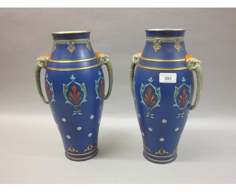 Pair of Villeroy &amp; Boch Mettlach baluster form vases with elephant mask handles, with incised decoration on a blue ground