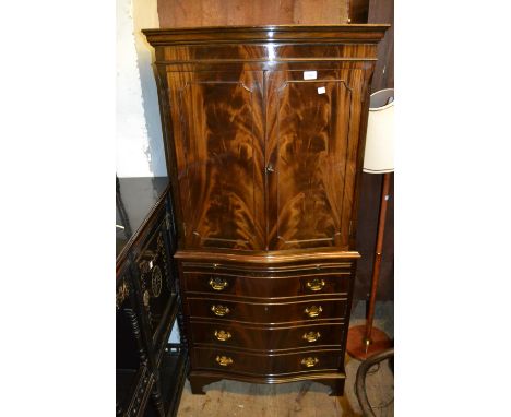 Reproduction figured mahogany cocktail cabinet, with a moulded cornice above a pair of figured panel doors, the base with a p