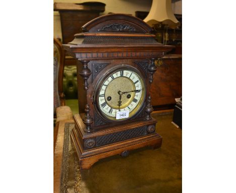 Late 19th Century German walnut mantel clock, the ceramic dial with Roman numerals with a two train movement striking on a go