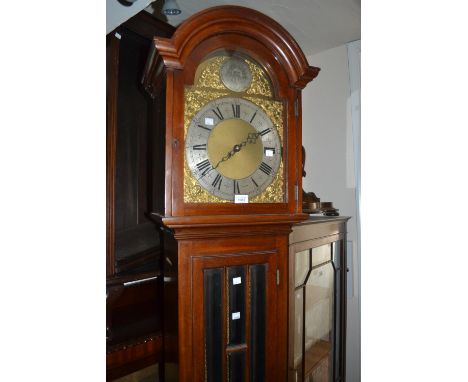 Mahogany longcase clock, the broken arch hood above a bevelled glass panelled door and conforming plinth base, the gilt brass