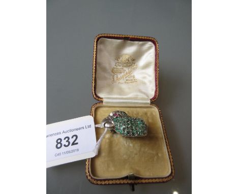 White metal brooch in the form of a parrot's head having ruby set eye and set emeralds (enamel worn), in fitted box, 1in 1/8t
