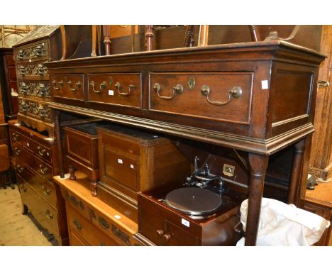 18th Century oak dresser, the boarded shelf back above three drawers raised on turned supports 