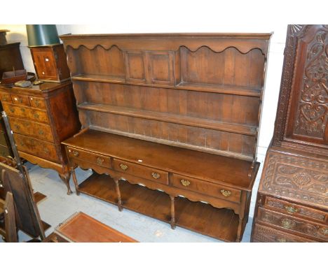 Large reproduction oak dresser, the boarded shelf back with two small panelled doors above three drawers raised on turned sup