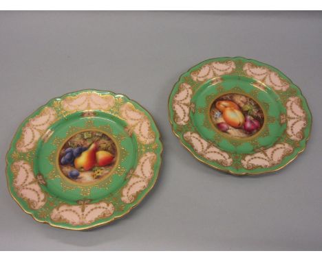 Pair of Royal Worcester plates, hand painted with various fruits by R. Seabright in circular central panels within green and 