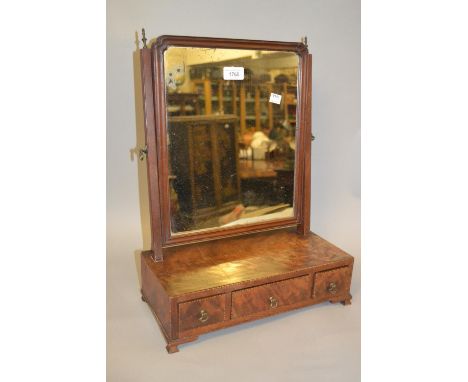 Early 19th Century mahogany swing frame rectangular dressing table mirror having three jewel drawers with brass handles, on o