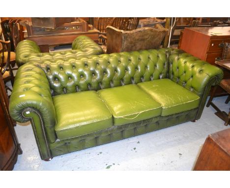 Green button leather upholstered three seat Chesterfield sofa together with a matching armchair 