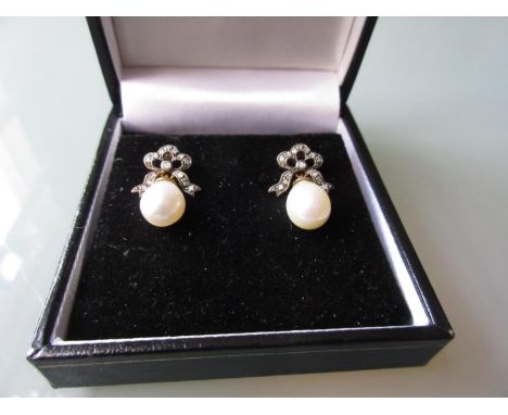 Pair of pearl and diamond bow form drop earrings 