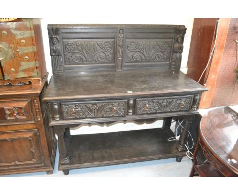 Victorian oak buffet with an earlier carved panel back above two frieze drawers, raised on turned supports 