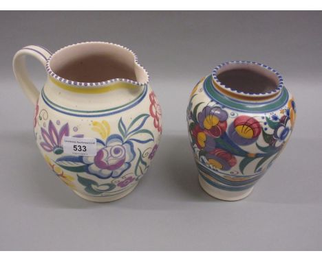 Poole Pottery baluster vase decorated with stylised flowers on a cream ground, together with a similar jug 