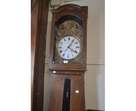 19th Century French comtoise longcase clock, the grained pine case enclosing an embossed brass and enamel dial with Roman num