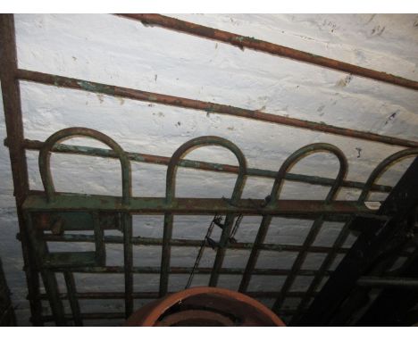 Early 20th Century green painted iron garden gate, 33ins wide, on gate posts, together with a matching green painted fence pa