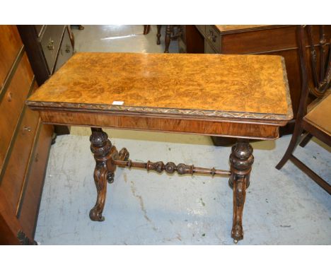 Victorian rectangular figured walnut fold-over card table on turned carved end supports with scroll feet 