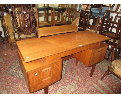 Mid 20th Century G-plan teak dressing table with a triple section mirror above a jewel drawers, two further drawers, cupboard