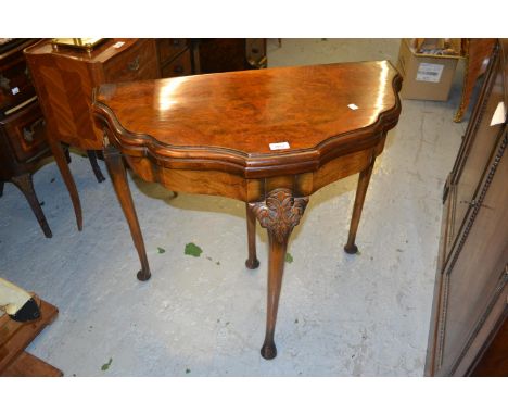 Mid 20th Century figured walnut card table, the shaped moulded top above carved cabriole supports, 32ins wide 