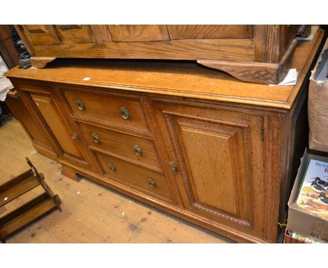 Early 20th Century oak sideboard with three central drawers flanked by rectangular panelled doors on shaped bracket feet 