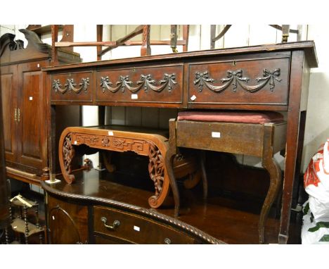 George III mahogany side table in Adam style, the moulded top above three frieze drawers relief moulded with swags raised on 