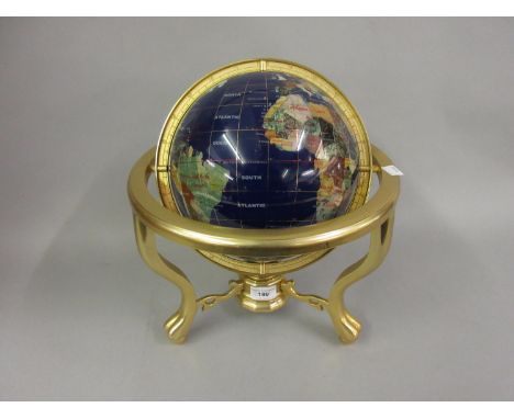 Reproduction globe inset with various minerals on a brass stand 