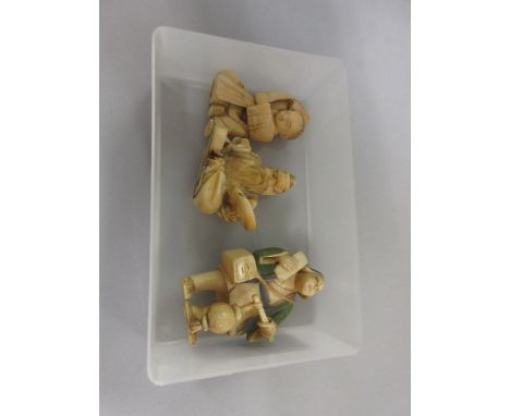 Japanese Meiji period netsuke in the form of a seated boy with a dragon costume, another of a seated figure holding a disc an