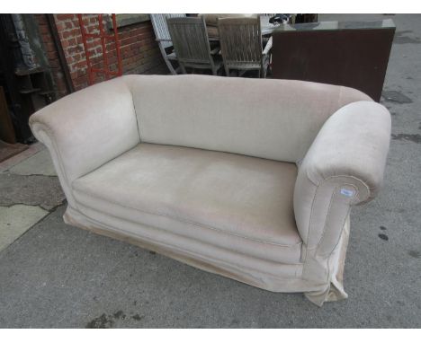 Late 19th or early 20th Century two seater Chesterfield type sofa with drop-end on four turned supports with casters 