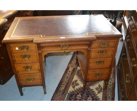 Small late 19th Century walnut inverted breakfront twin pedestal desk, the red tooled leather inset moulded top above nine dr