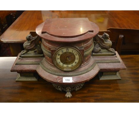 Unusual 19th Century French rouge marble and gilt metal mounted mantel clock, the enamel and brass dial with Arabic numerals,