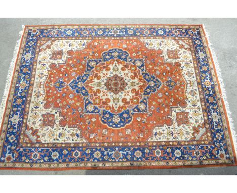 Indo Persian carpet with a medallion and all-over floral design on a rust ground with borders 