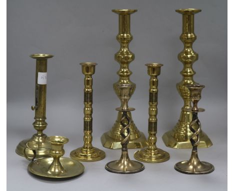 Three pairs of brass candlesticks, another and a candlestick holder