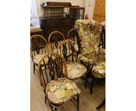 An Ercol suite comprising six chairs, two armchairs, a coffee table and a sideboard