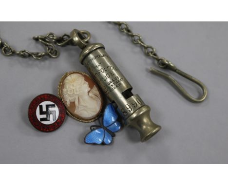 A Nazi badge, a silver enamel butterfly, a compass and a police whistle, etc