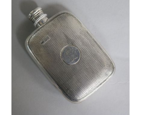 A Victorian engine turned silver hip flask, by Thomas Johnson I, London, 1871, 12cm.