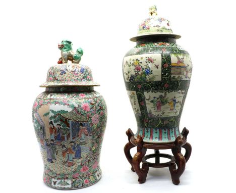 A Chinese famille rose vase and cover, 20th century, of baluster form, painted with figures in shaped panels surrounded by pr