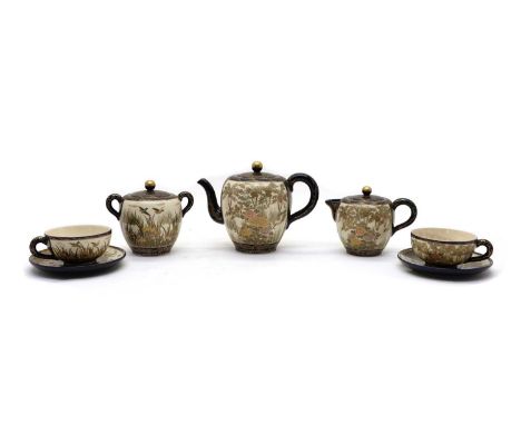 A Japanese satsuma ware tea service,c.1900, comprising: a teapot, milk jug, sugar bowl, six cups and saucers, decorated with 