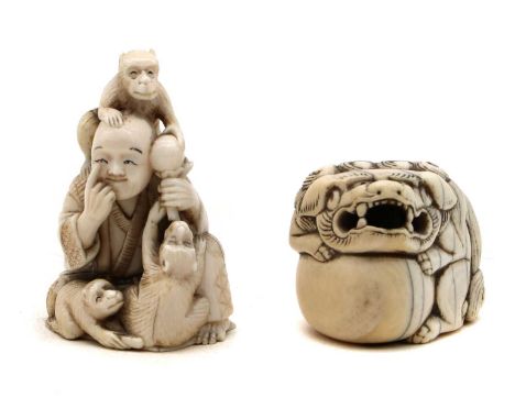 A Japanese ivory netsuke,early 20th century, carved with a Buddhist lion holding a ball, 3.6cm widetogether with a further ex