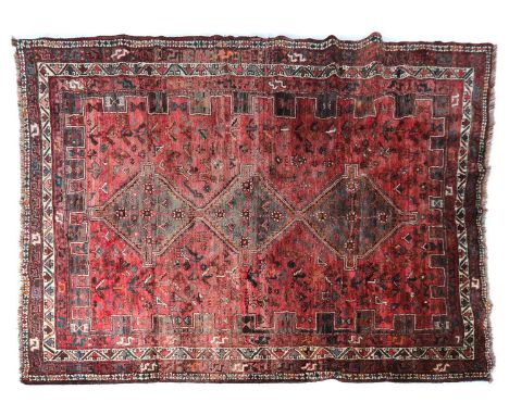 A Qashqai carpet, with three adjoined medallions enclosed by a castellated border, 316 x 228cmCondition report: Losses to tas